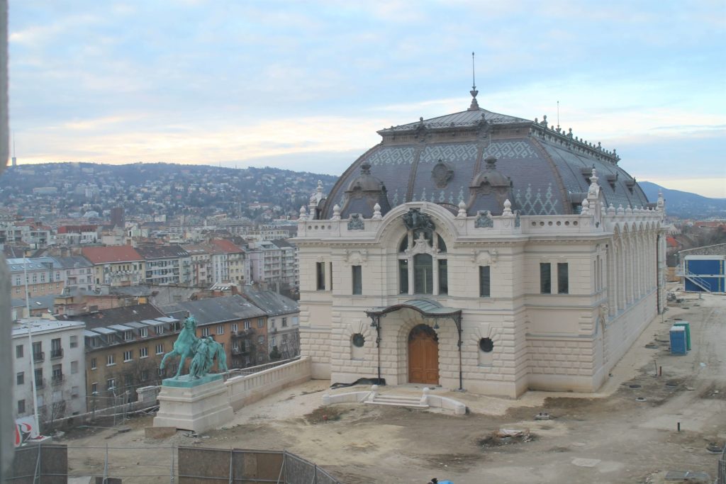 The Riding Hall with consturction site and view of the city