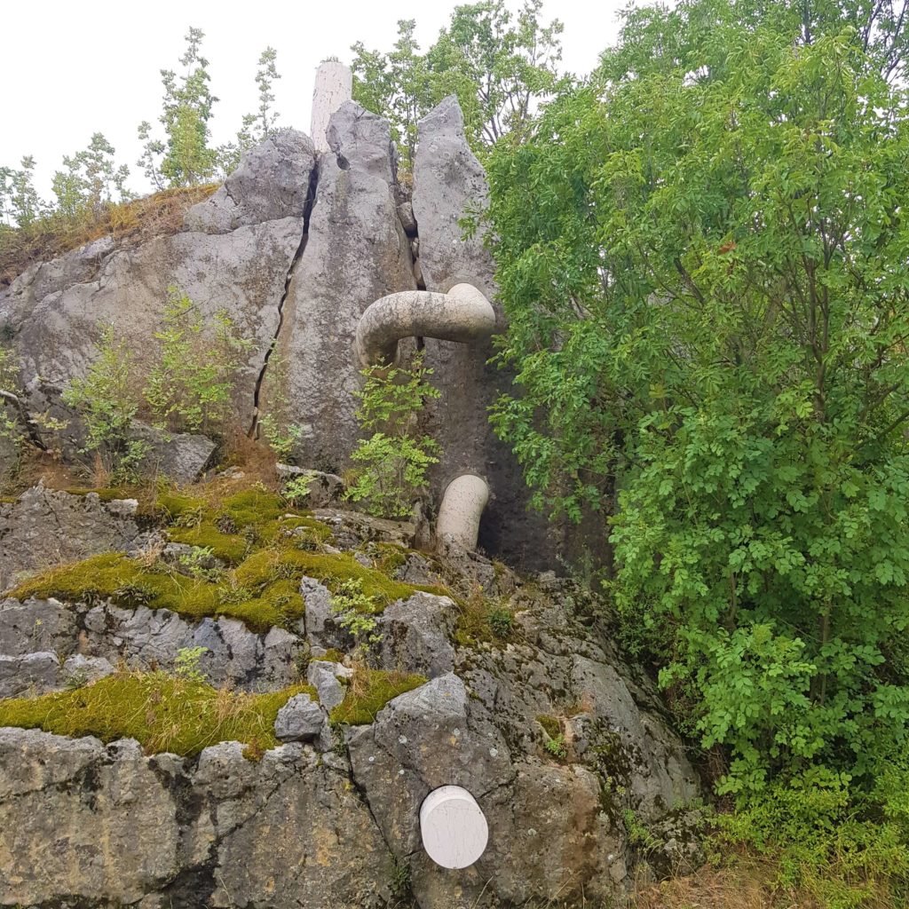 rock wall with abstract stone statue