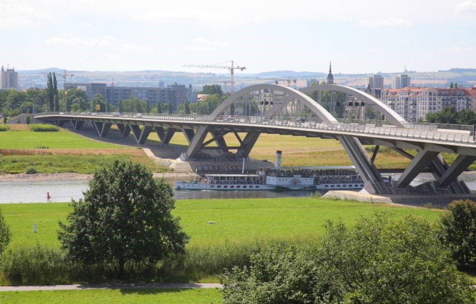 The image shows the Waldschlößchen Bridge on the Elbe River and the Stark contrast in its Architectural design.