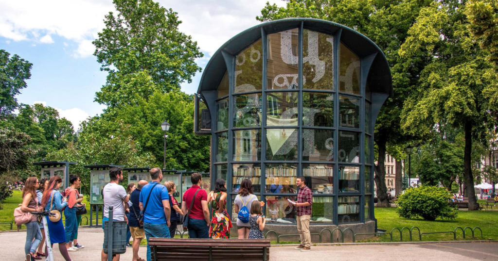 A small group of people gather in a park