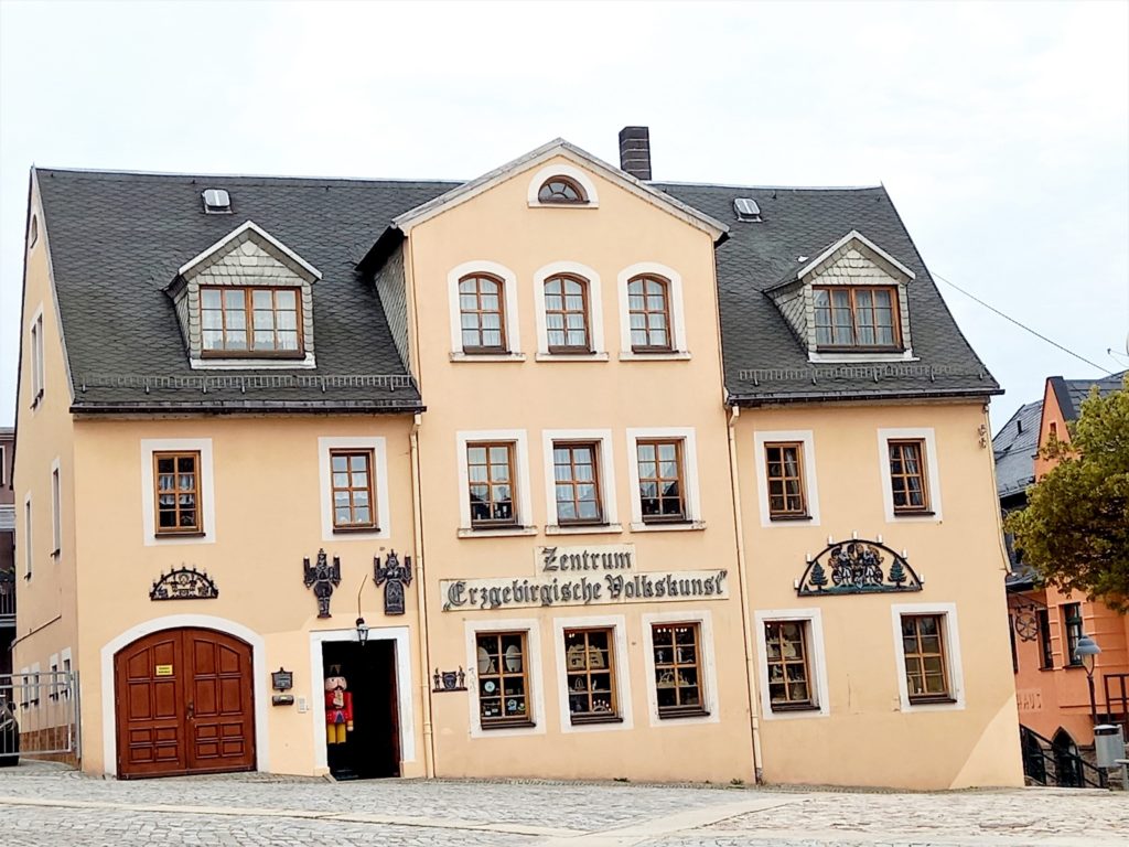 Townhouse with black roof and facade decorations