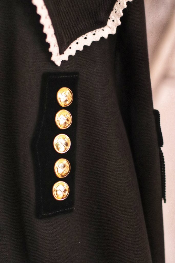 Black jacket with golden buttons with the miners' symbol